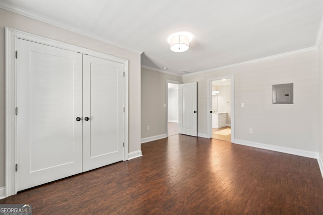 unfurnished bedroom with electric panel, dark wood-style flooring, baseboards, crown molding, and a closet