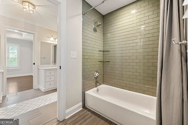 bathroom with shower / bath combination with curtain, crown molding, baseboards, vanity, and wood finished floors