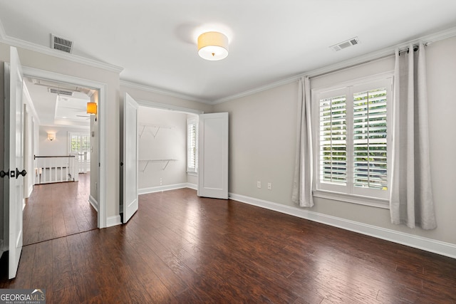 unfurnished bedroom with dark wood-style floors, multiple windows, baseboards, and crown molding