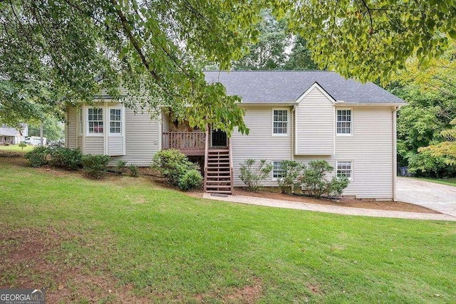view of front of property with stairs and a front lawn