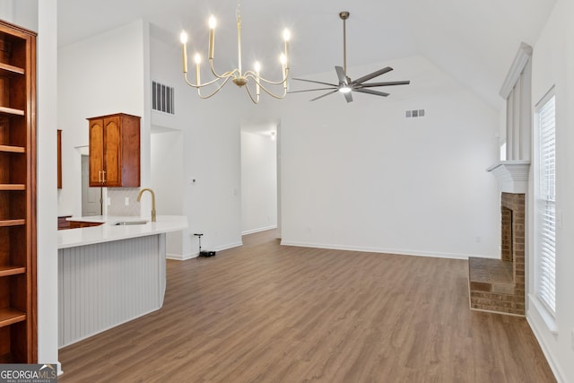 103 St Albans Way, Peachtree City, GA 30269 - unfurnished living room featuring visible vents, a sink, ceiling fan with notable chandelier, and wood finished floors
