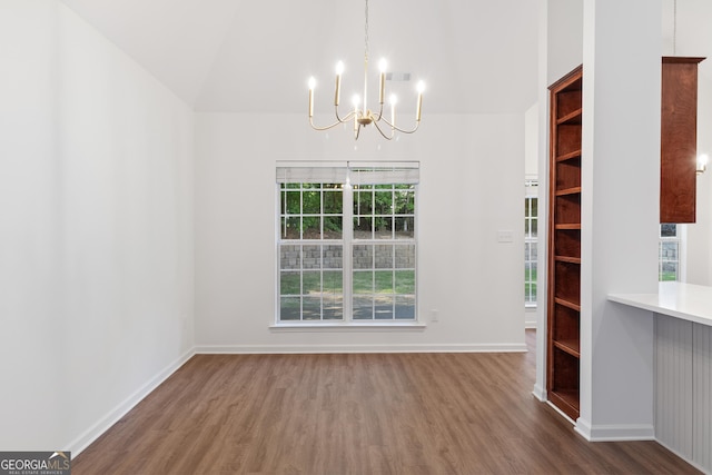 103 St Albans Way, Peachtree City, GA 30269 - unfurnished dining area with baseboards, an inviting chandelier, wood finished floors, and high vaulted ceiling
