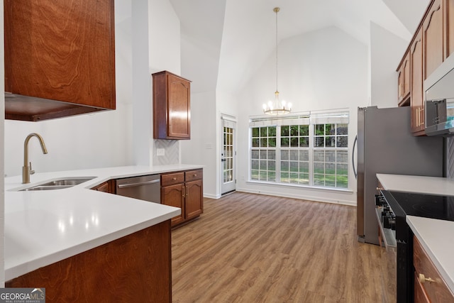 103 St Albans Way, Peachtree City, GA 30269 - kitchen featuring hanging light fixtures, a sink, high vaulted ceiling, an inviting chandelier, and stainless steel appliances