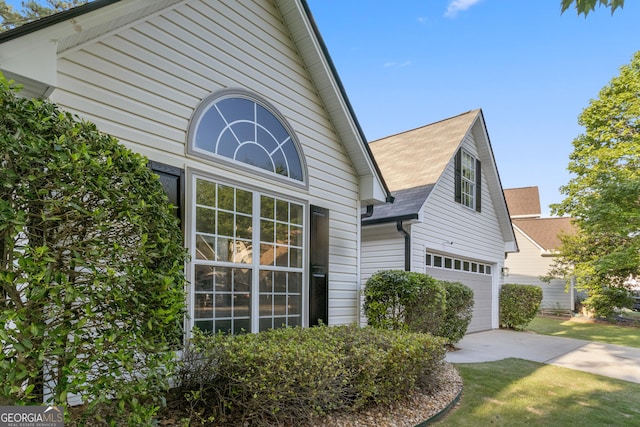 103 St Albans Way, Peachtree City, GA 30269 - view of side of home featuring a garage, roof with shingles, and concrete driveway