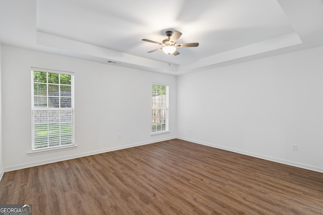 103 St Albans Way, Peachtree City, GA 30269 - unfurnished room with a raised ceiling, ceiling fan, wood finished floors, and a wealth of natural light