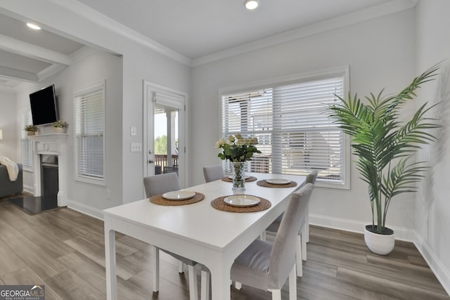 7108 Birch View Ct, Flowery Branch, GA 30542 - dining area featuring wood finished floors, a fireplace with raised hearth, ornamental molding, recessed lighting, and beamed ceiling