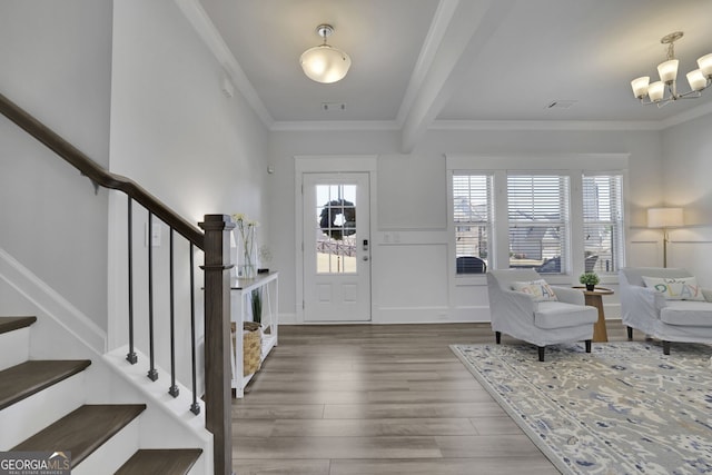 7108 Birch View Ct, Flowery Branch, GA 30542 - foyer with crown molding, wood finished floors, stairs, a chandelier, and a decorative wall