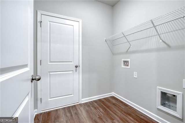 washroom featuring dark wood-style floors, baseboards, hookup for a washing machine, and laundry area