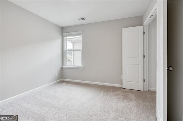 unfurnished room featuring visible vents, carpet flooring, and baseboards