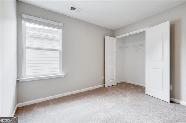 unfurnished bedroom featuring baseboards, visible vents, and carpet floors