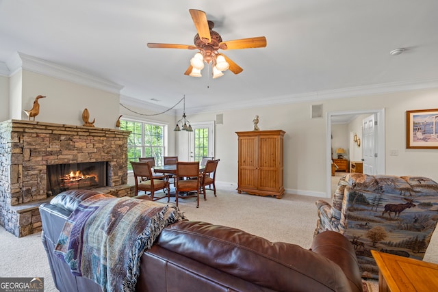 living area with visible vents, ornamental molding, a fireplace, and light colored carpet