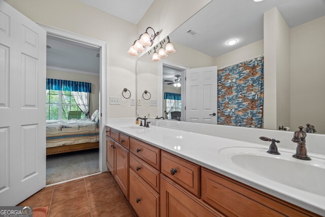 bathroom with tile patterned floors, a sink, double vanity, visible vents, and connected bathroom