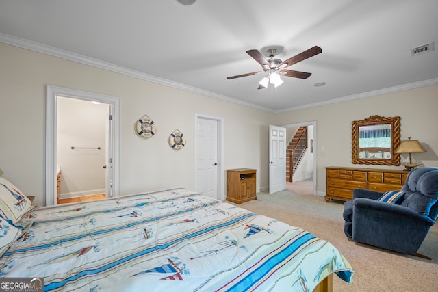 bedroom featuring visible vents, ornamental molding, baseboards, light colored carpet, and ceiling fan
