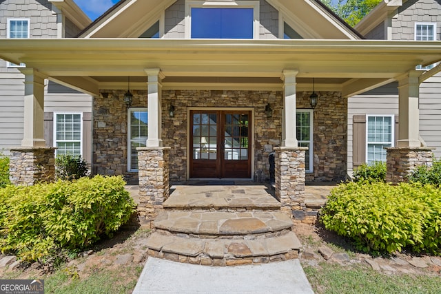entrance to property with stone siding and covered porch