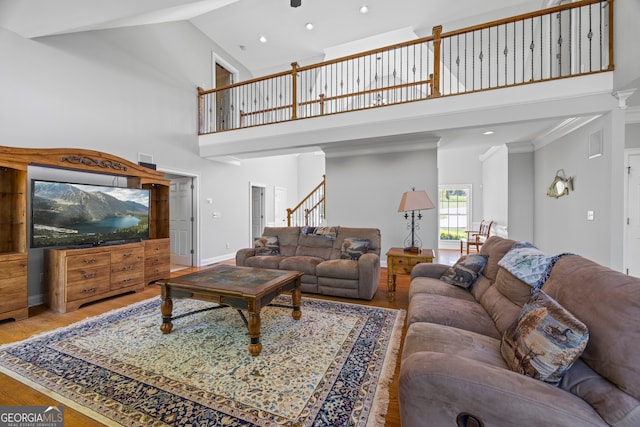 living room featuring recessed lighting, wood finished floors, high vaulted ceiling, and stairway