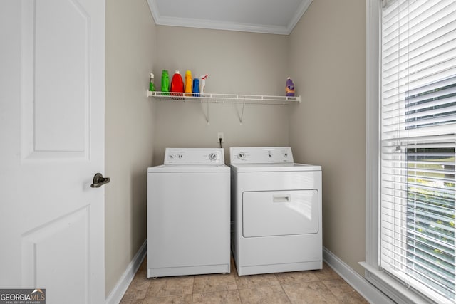 clothes washing area with washing machine and dryer, baseboards, ornamental molding, and laundry area