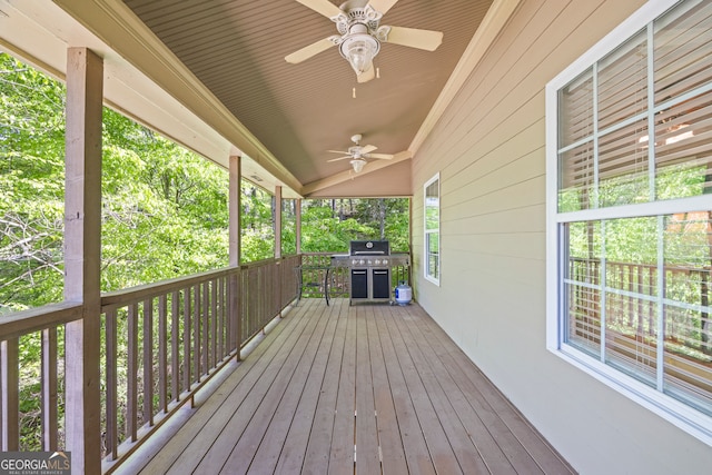 wooden terrace featuring grilling area and ceiling fan