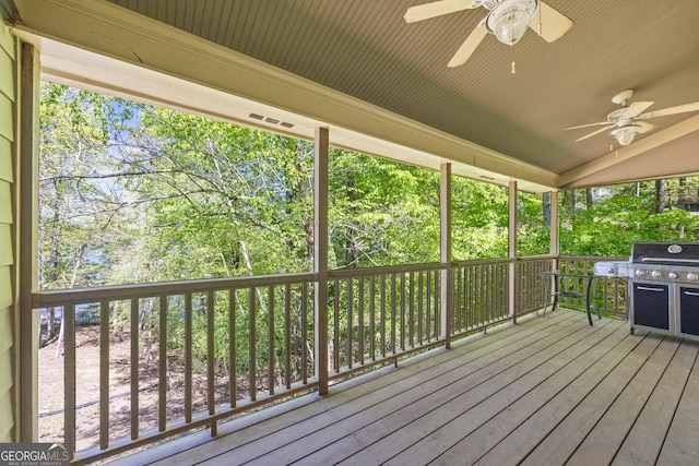deck with a ceiling fan and area for grilling