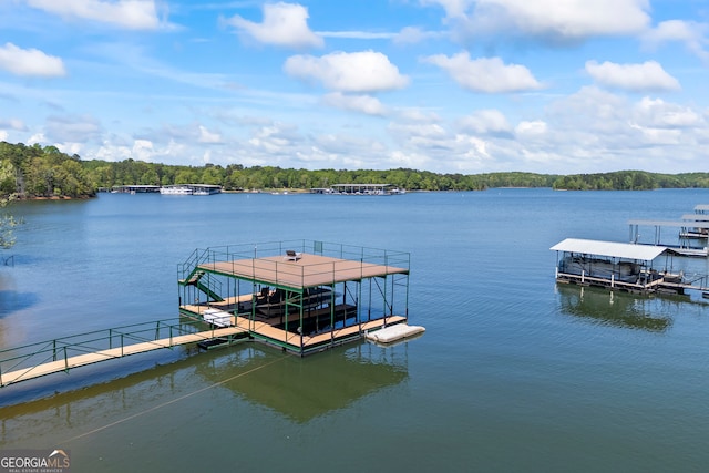 view of dock featuring a forest view, a water view, and boat lift