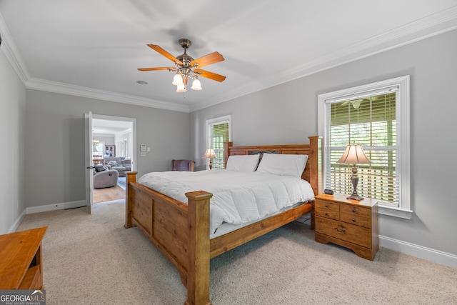 bedroom with light carpet, a ceiling fan, baseboards, and crown molding