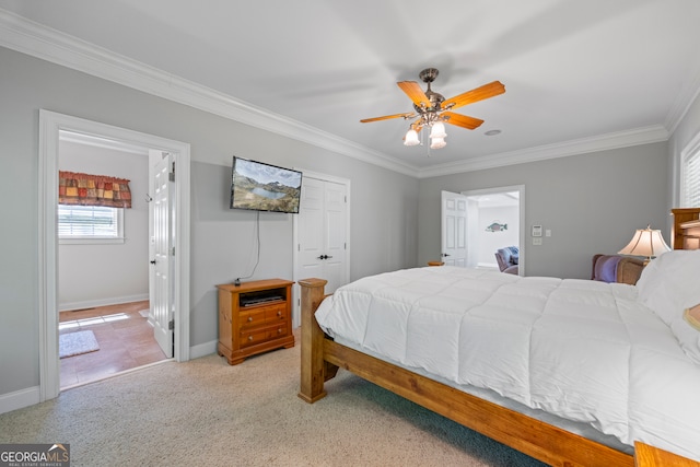 bedroom featuring baseboards, ornamental molding, and light colored carpet