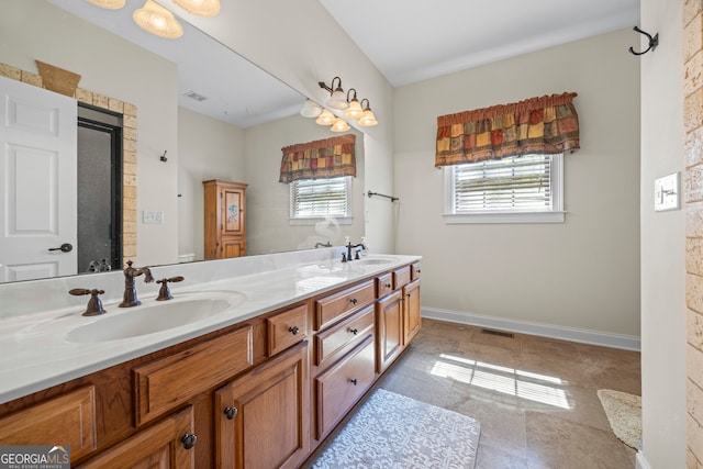 full bathroom with double vanity, visible vents, baseboards, and a sink