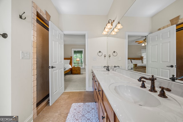 ensuite bathroom with tile patterned flooring, ensuite bath, a sink, and double vanity