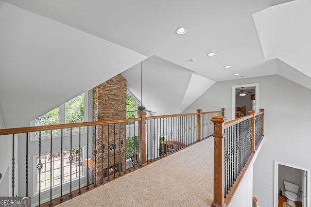hall with vaulted ceiling and recessed lighting