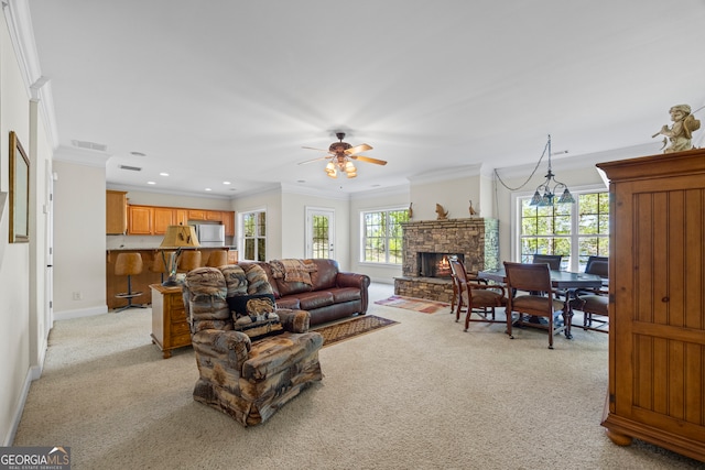 living room featuring light carpet, ornamental molding, visible vents, and a wealth of natural light