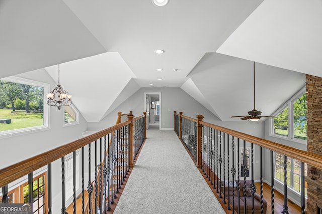 corridor featuring lofted ceiling, plenty of natural light, an inviting chandelier, and recessed lighting