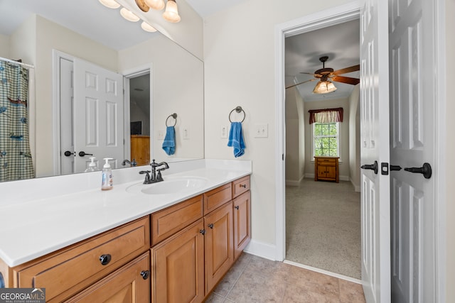 bathroom with vanity, a ceiling fan, baseboards, and tile patterned floors