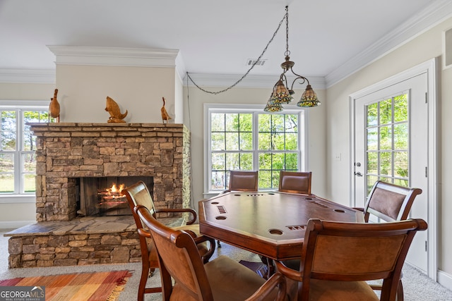 living area with a stone fireplace, visible vents, baseboards, and ornamental molding