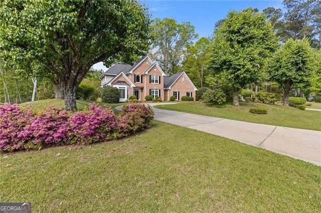 view of front of property featuring a front yard and concrete driveway