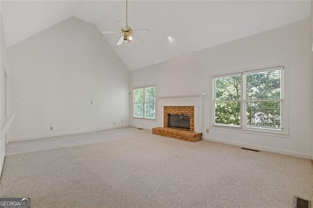 unfurnished living room with high vaulted ceiling, ceiling fan, carpet floors, and visible vents