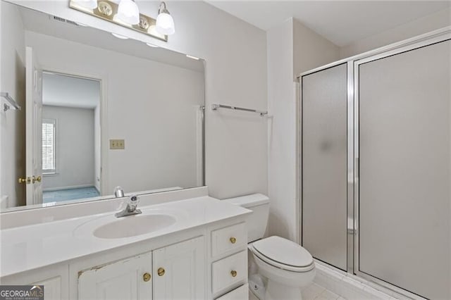 bathroom with toilet, vanity, visible vents, and a stall shower