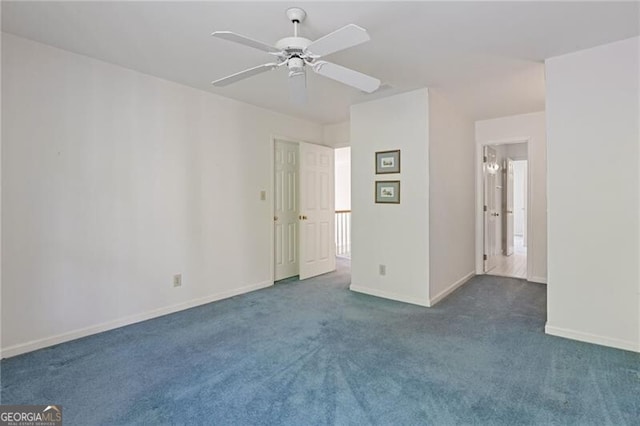 interior space featuring baseboards, a ceiling fan, and dark colored carpet