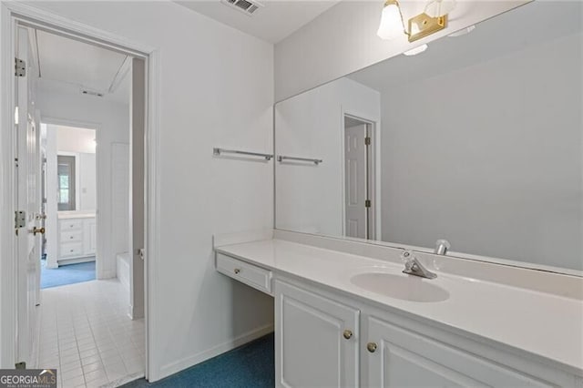 bathroom with baseboards, visible vents, and vanity