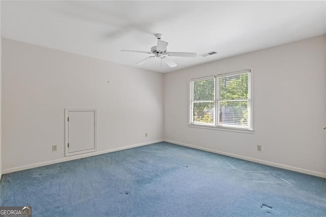 carpeted empty room with visible vents, baseboards, and ceiling fan