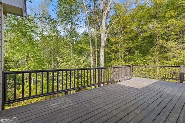 wooden deck featuring a wooded view