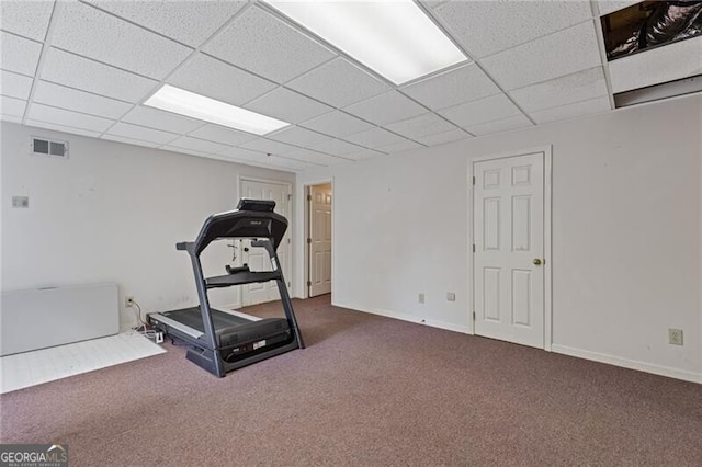 exercise room with carpet floors, a drop ceiling, and visible vents