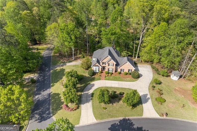 birds eye view of property featuring a view of trees