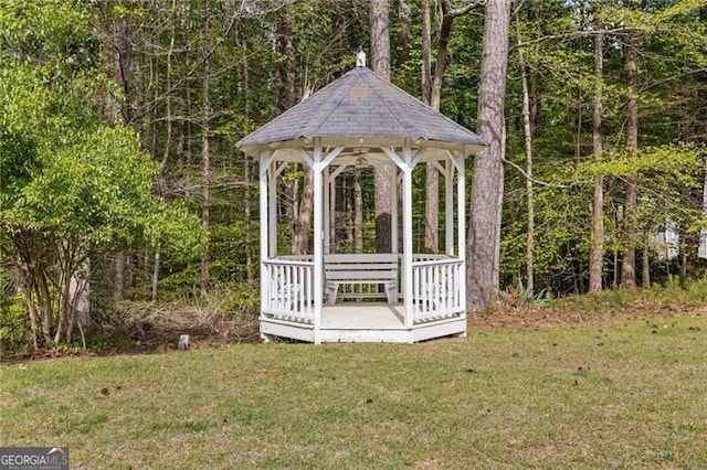 view of outbuilding featuring a forest view and a gazebo