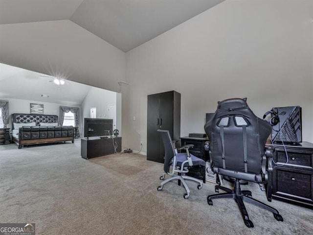 office space featuring baseboards, vaulted ceiling, and carpet