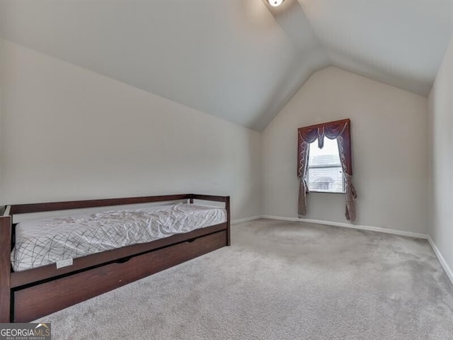 unfurnished bedroom with baseboards, vaulted ceiling, and carpet flooring