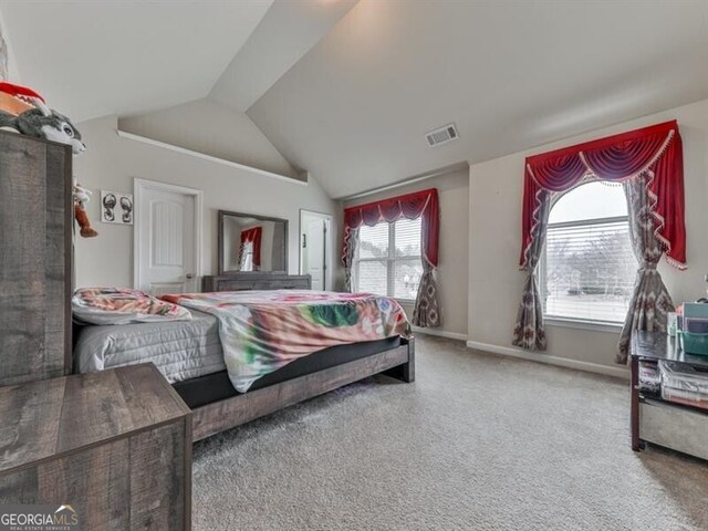bedroom featuring lofted ceiling, visible vents, carpet flooring, and baseboards