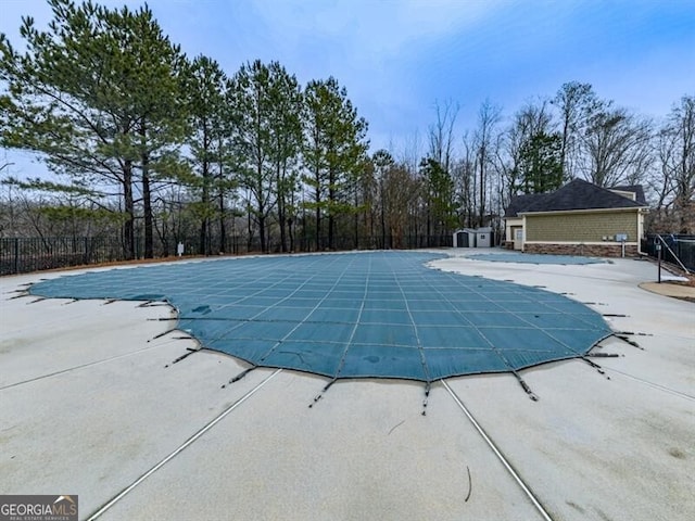 pool featuring fence and a patio