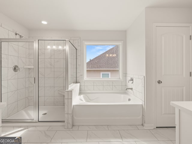 7162 Linden Dr, South Fulton, GA 30349 - bathroom featuring marble finish floors, a garden tub, a stall shower, and recessed lighting
