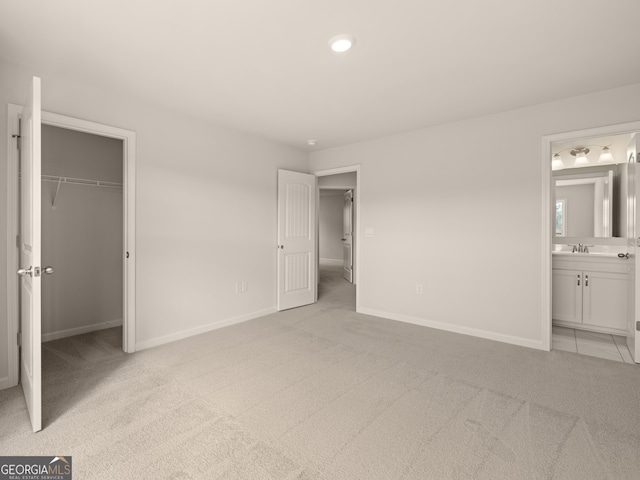 7162 Linden Dr, South Fulton, GA 30349 - unfurnished bedroom featuring light carpet, a walk in closet, ensuite bathroom, and a closet