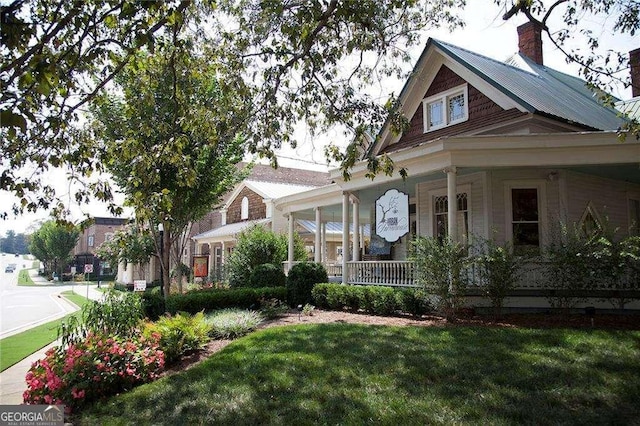 135 Alcovy Ter, Alpharetta, GA 30009 - view of front facade with a porch, a front yard, and a chimney