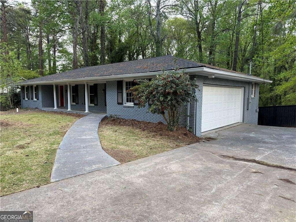 2899 Tejas Trl, Atlanta, GA 30331 - ranch-style house with driveway, an attached garage, brick siding, and covered porch